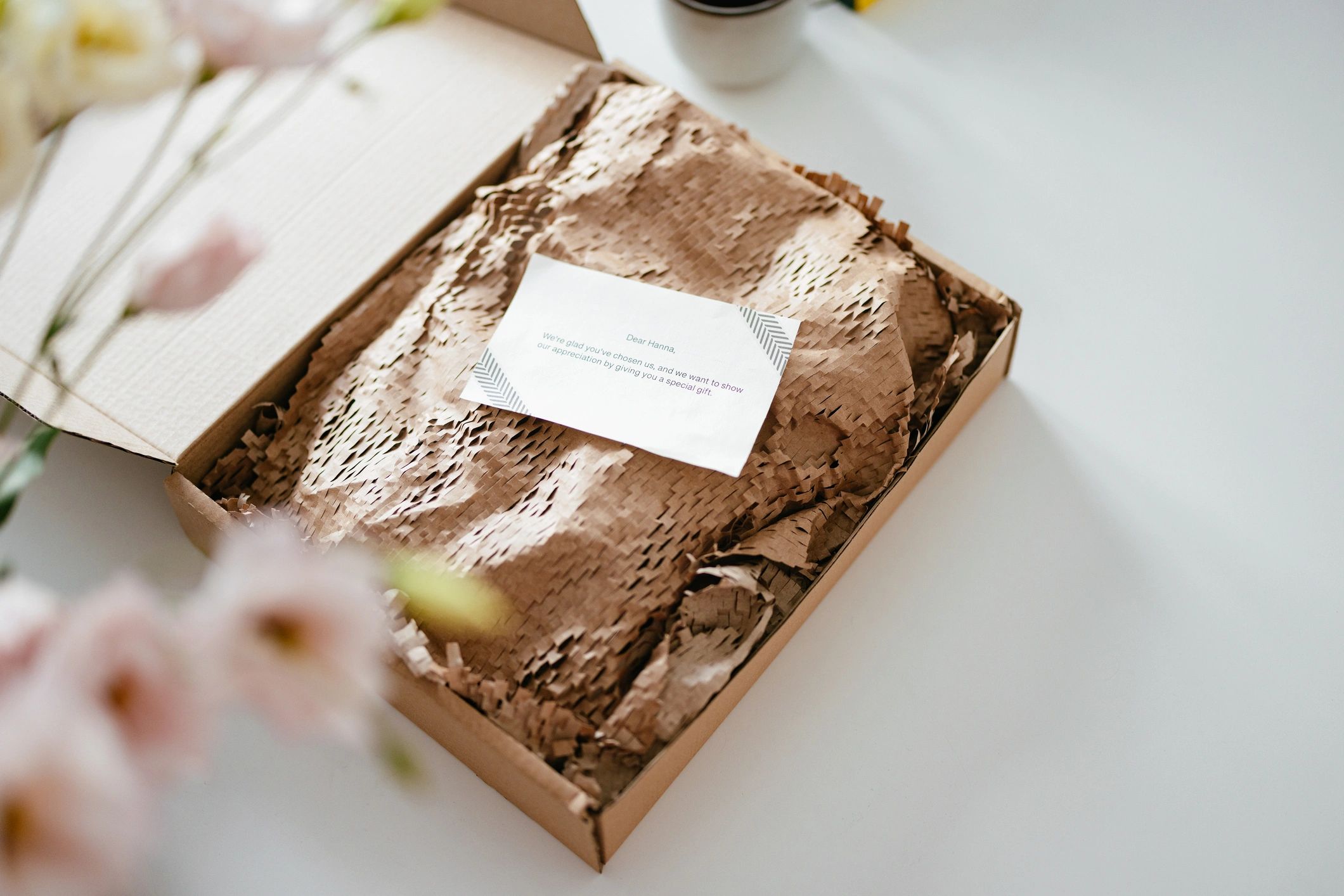Paper-wrapped products in a carton box representing sustainable packaging
